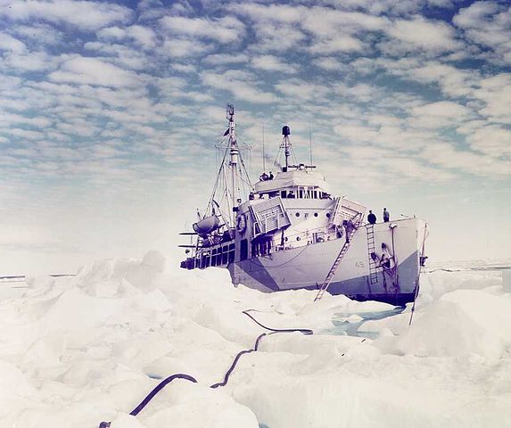 A rare color photograph of Coast Guard ice vessel Northland seen with arctic camouflage while trapped in the ice. (Coast Guard Collection)